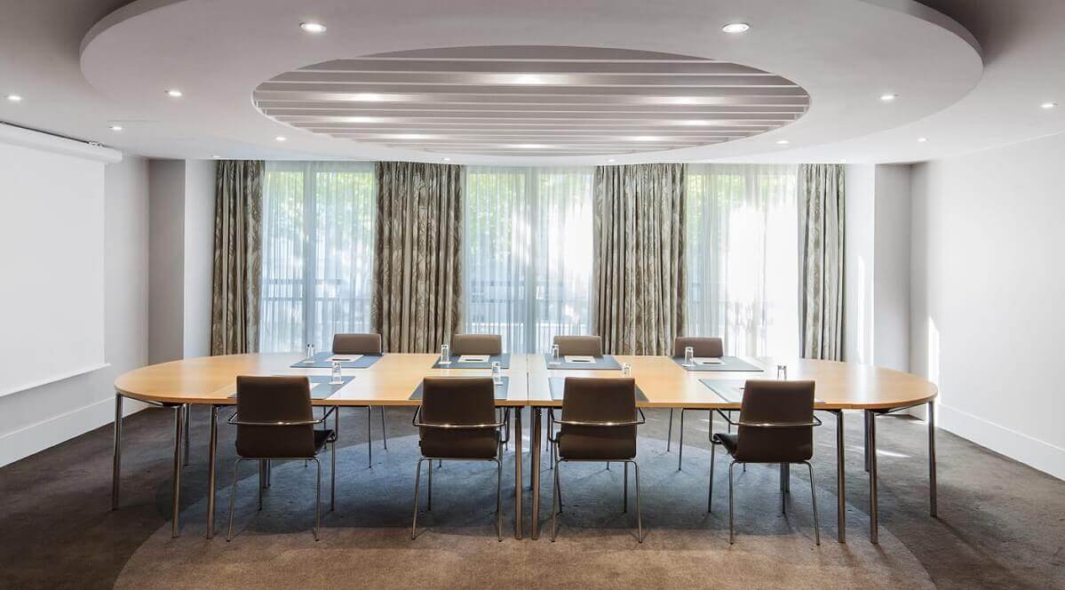 Small conference room Meeting room in the hotel with a large conference table and eight chairs in the middle of the room
