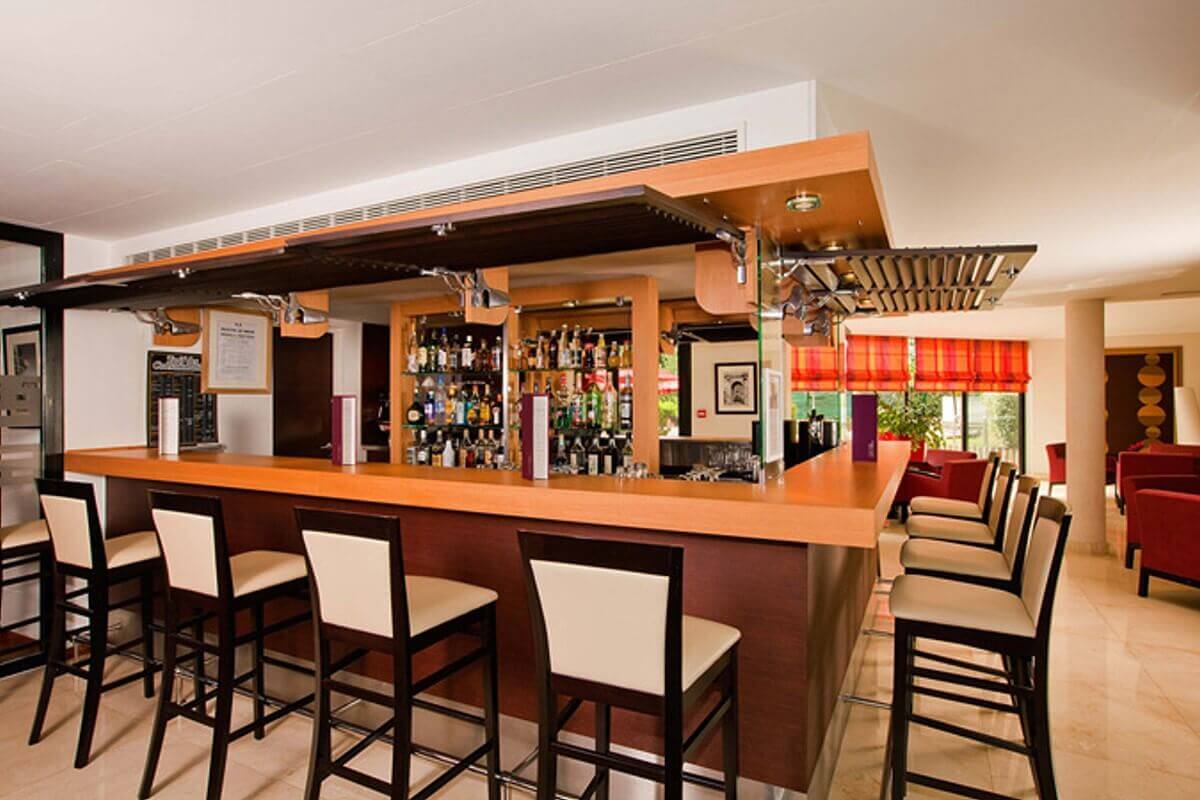 Hotel bar Hotel bar in the Residhome. Around the bar are bar stools, in the background a well filled liquor shelf