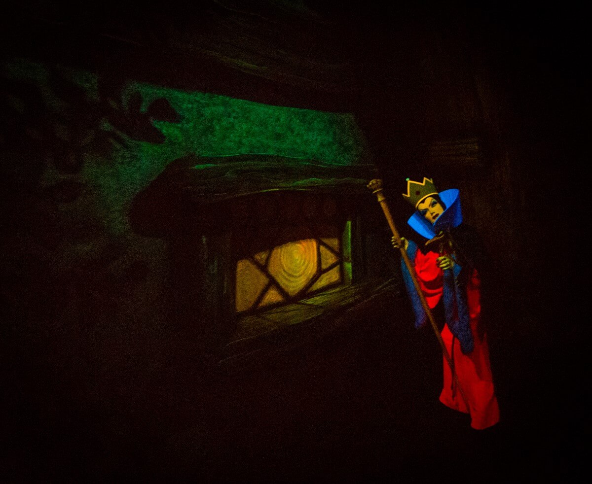 Performance of the Evil Queen the Evil Queen can be seen in front of a window of the dwarf's house