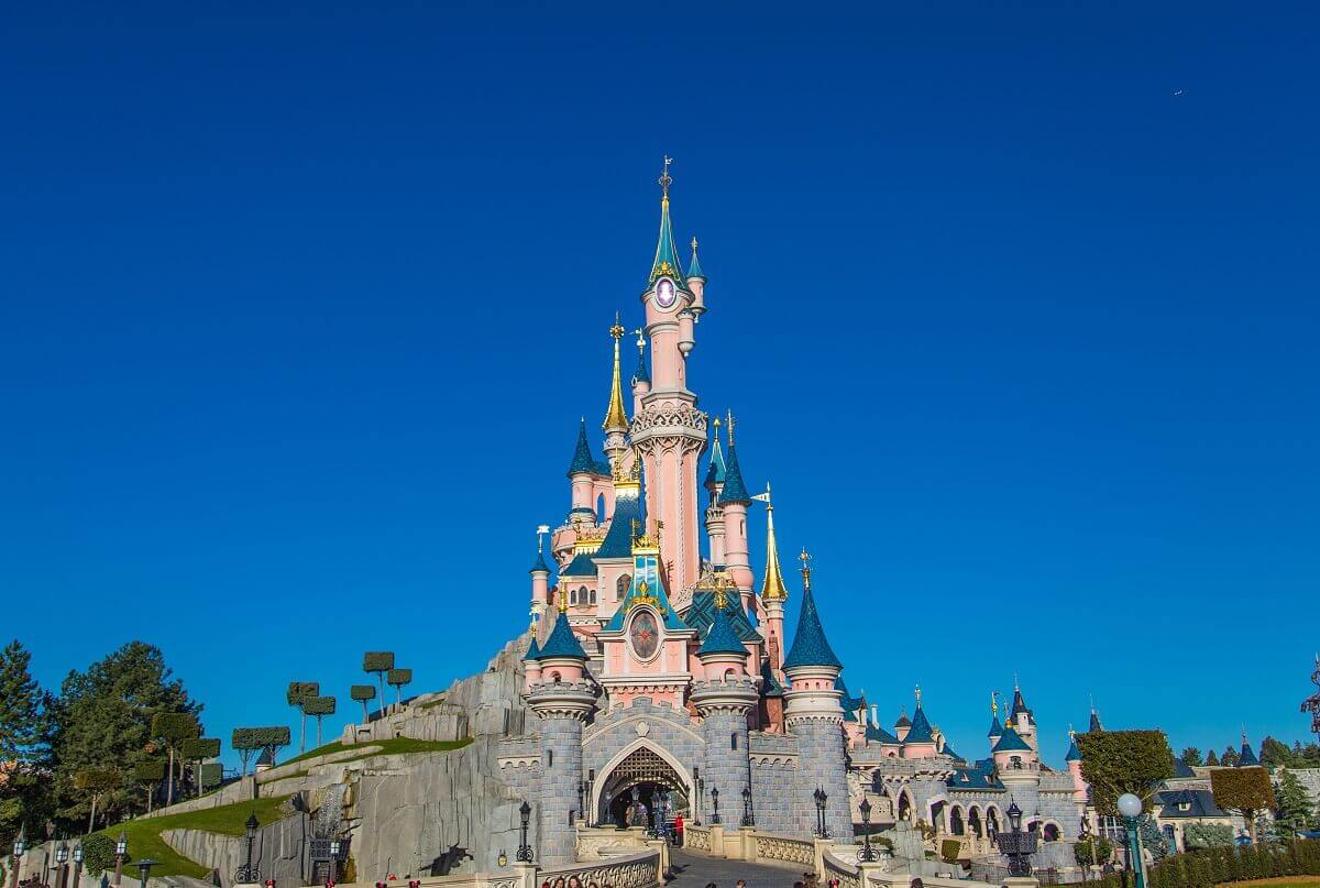 The Dornroeschen Castle in Disneyland Park From the Central Plaza you look at Sleeping Beauty Castle against a bright blue sky