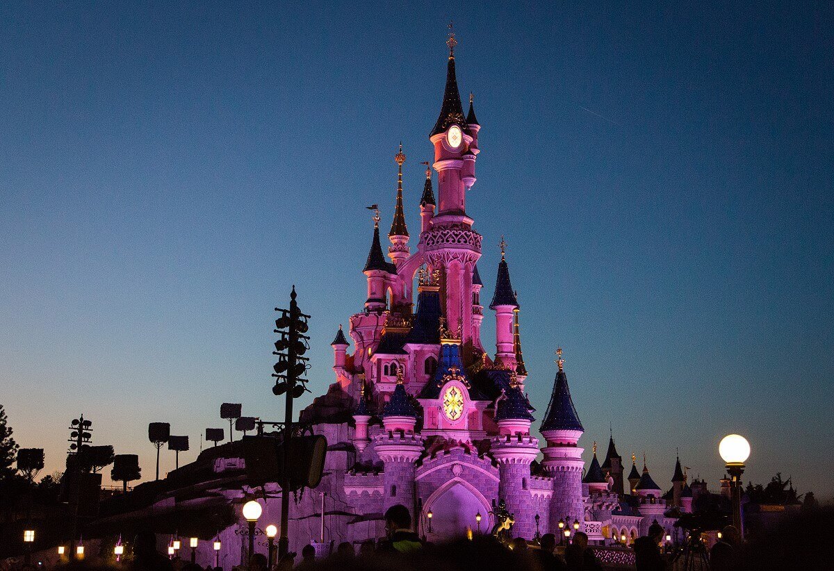Evening shot of the castle View of the pink shining castle with illuminated windows in the evening