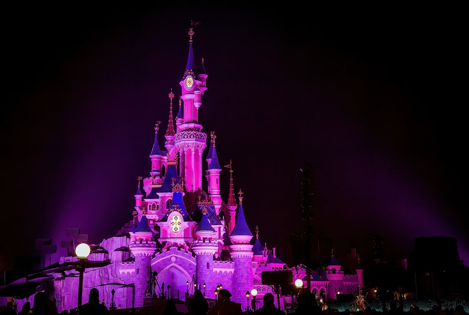 Sleeping Beauty Castle in the dark Sleeping Beauty Castle in the dark in the light of purple spotlights