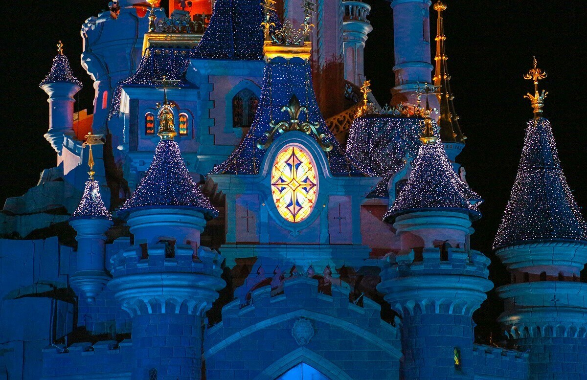 Glittering gables at the castle Close up of the glittering roofs of Sleeping Beauty Castle at night