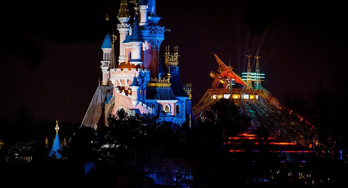 Hyperspace Mountain and the Castle View of Hyperspace Mountain and Sleeping Beauty Castle in the dark