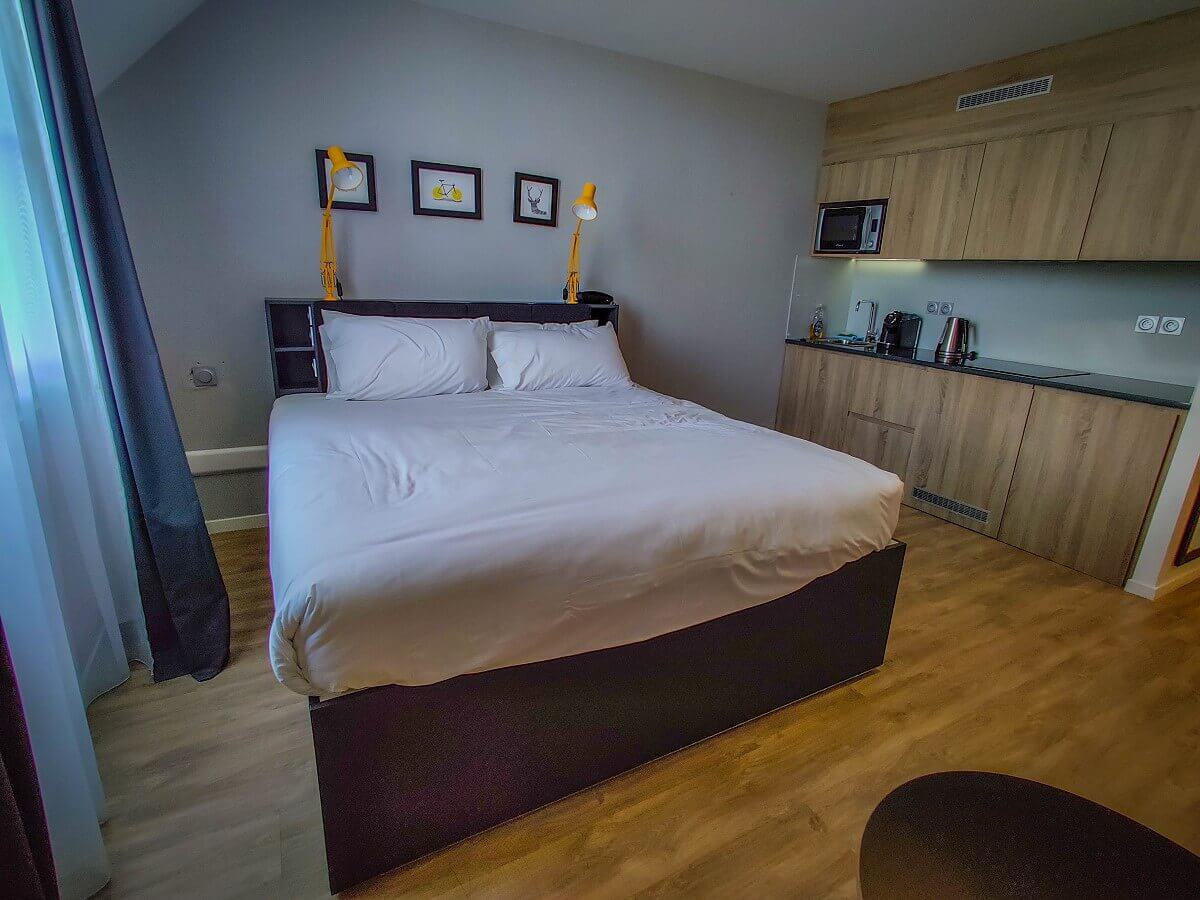 King size bed View of the king size bed and kitchenette in the hotel room