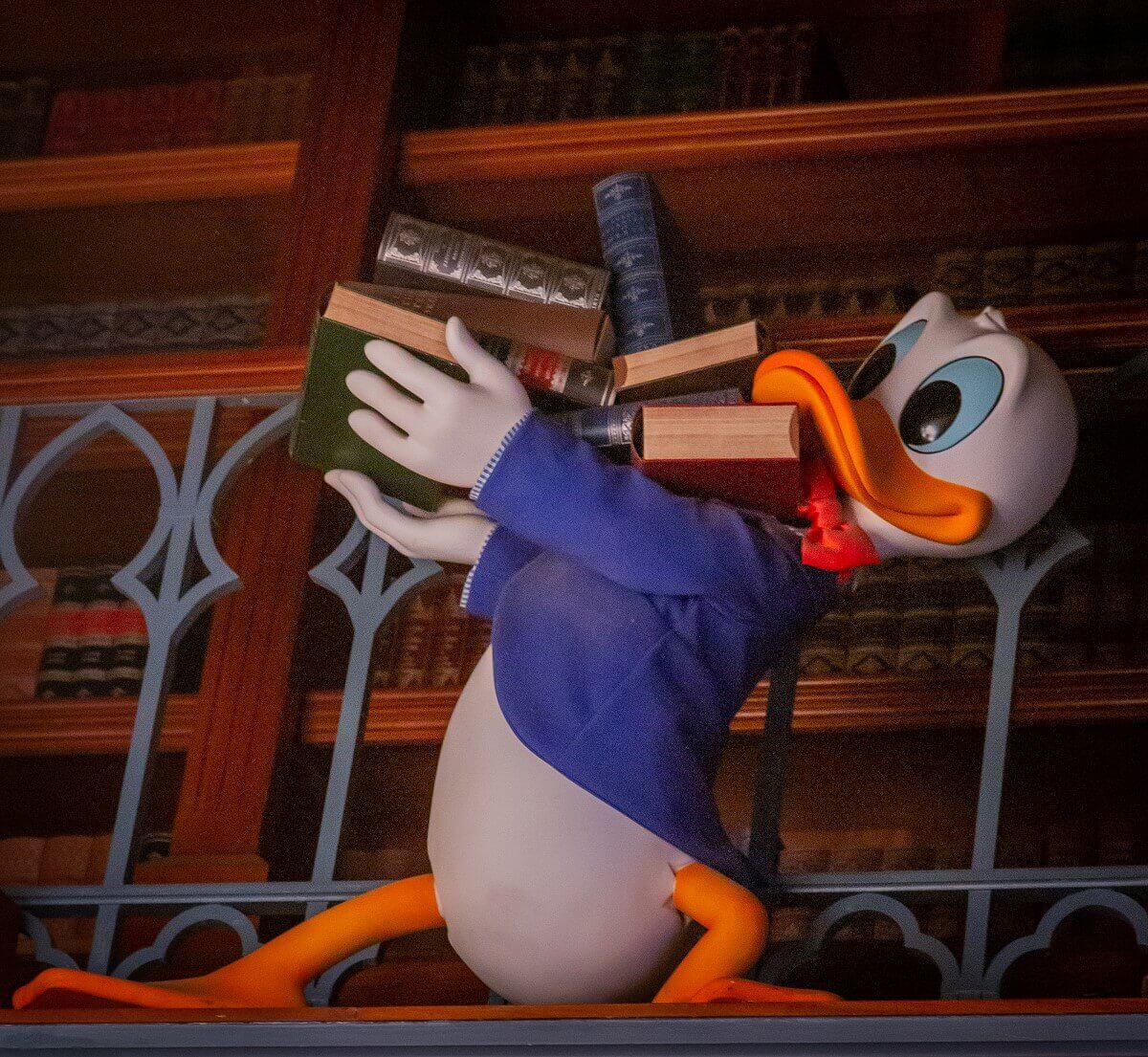 Donald Duck with books Donald Duck carries a very unevenly stacked pile of books