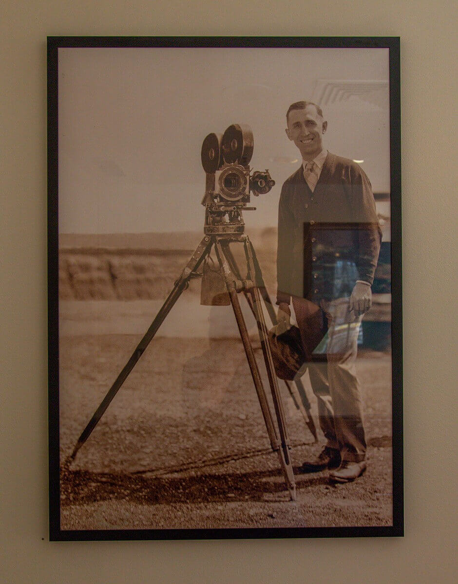 Roy O. Disney Old shot of Roy O. Disney shooting for the Alice Comedies next to a movie camera on a tripod.