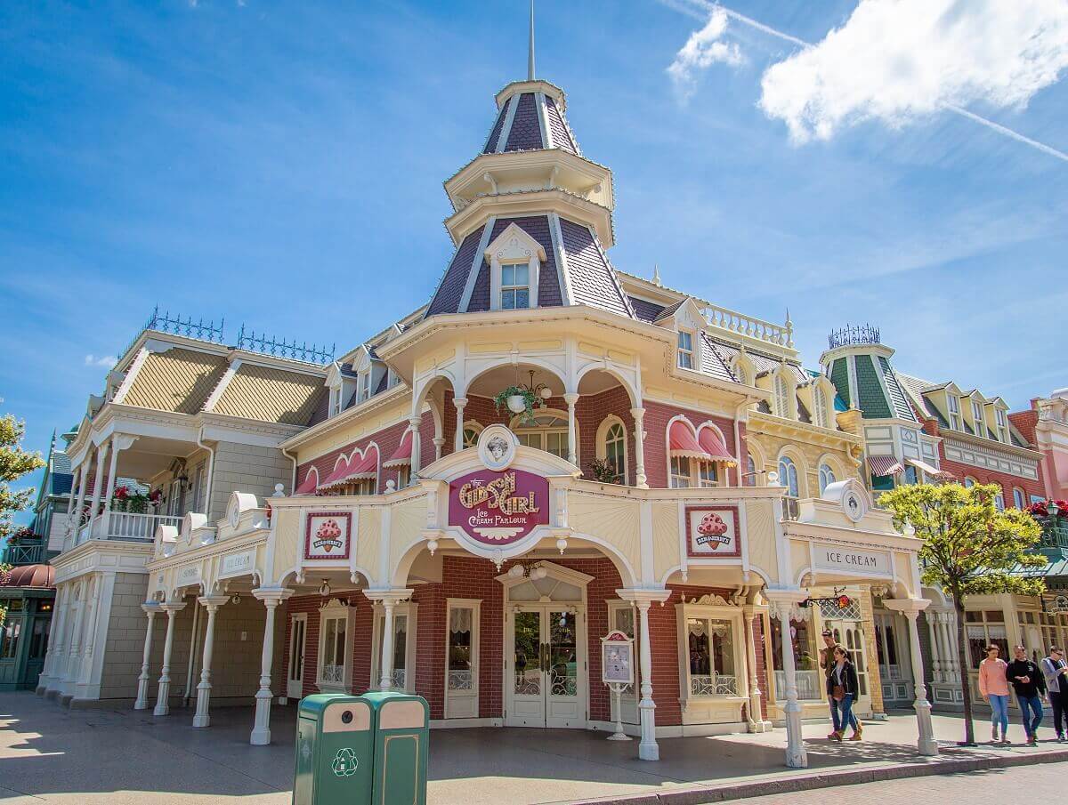 The Gibson Girl Ice Cream Parlor The Gibson Girl Ice Cream Parlor exterior. Red brick building with white wood porch, a corner tower, and pink awnings over the upstairs windows.