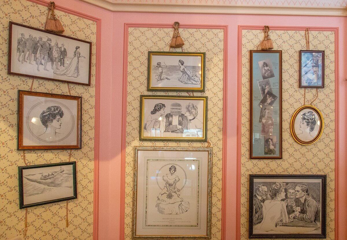 A multitude of framed charcoal drawings on a wall A multitude of framed charcoal drawings on a wall