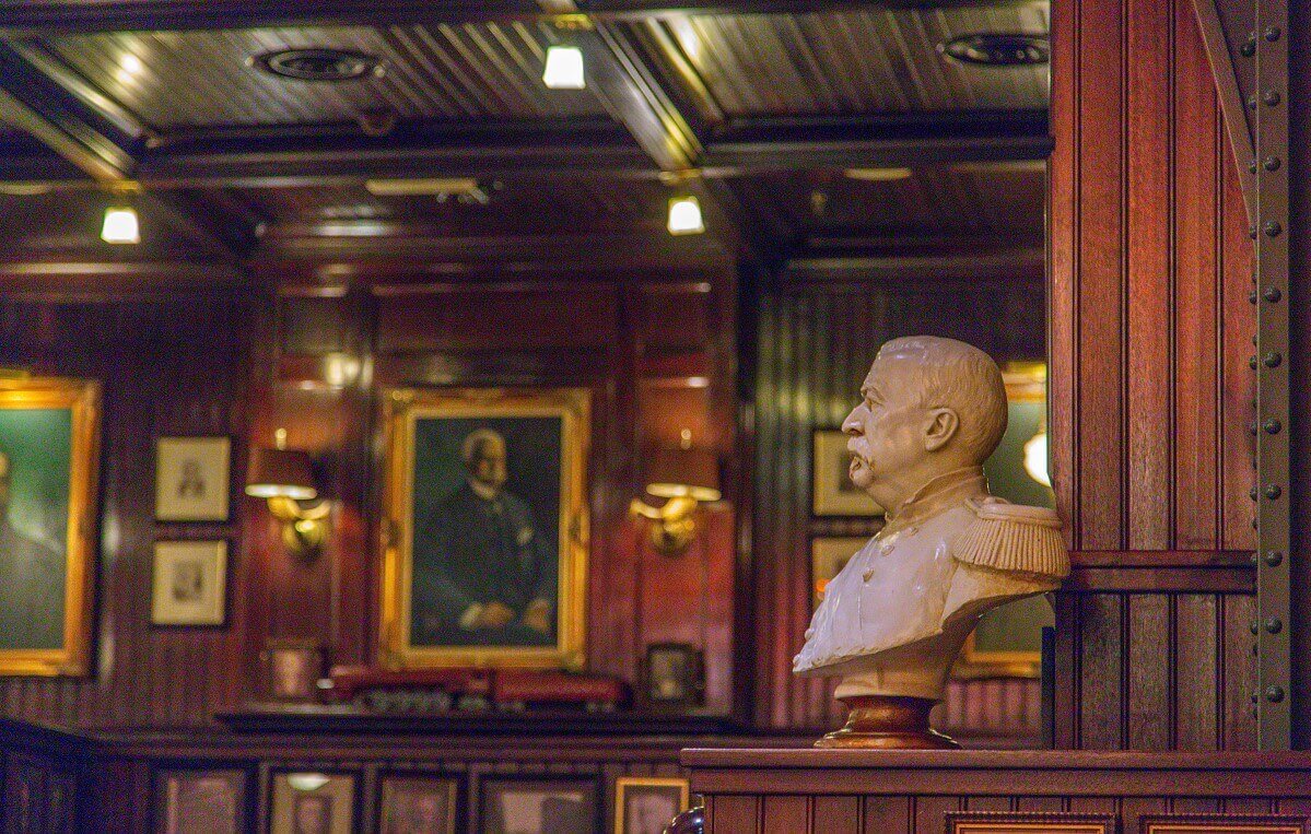 Bust of a railway tycoon in military uniform Bust of a railway tycoon in military uniform, in the background a fireplace with a model railway on the ledge and oil painting