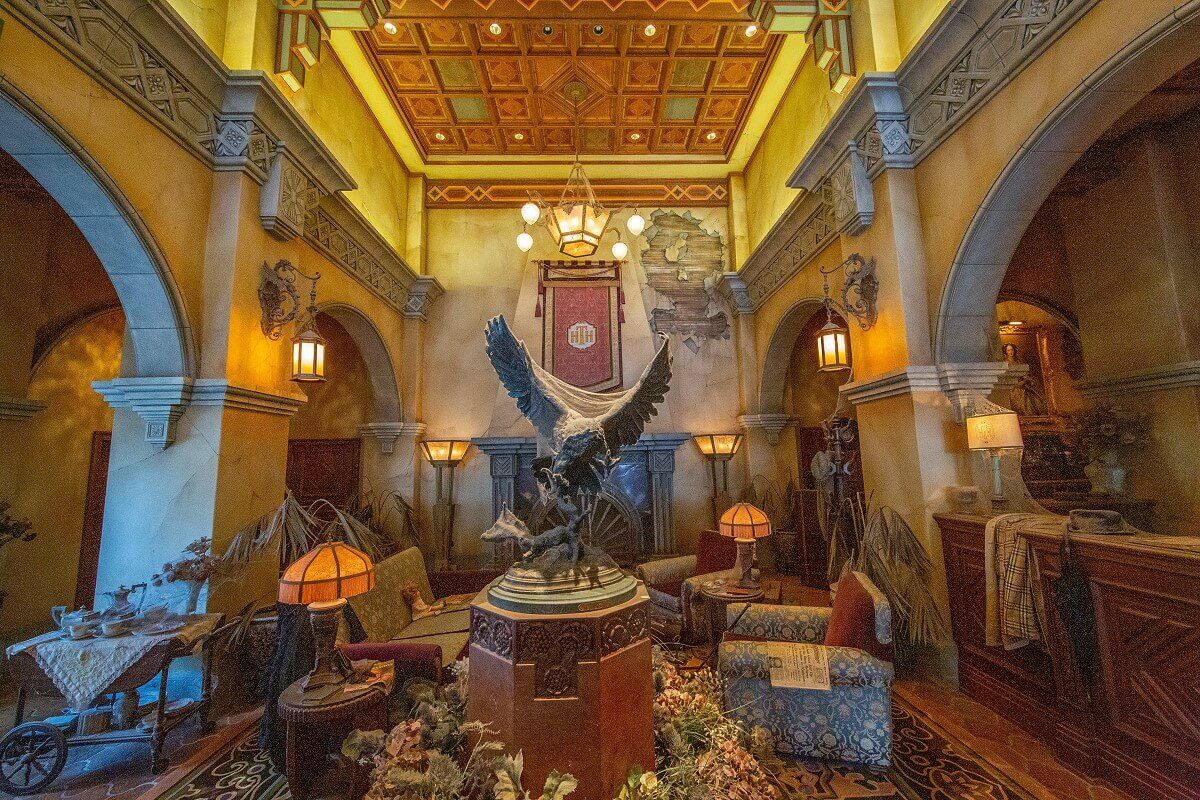 Lounge & Reception Reception of the Hollywood Tower Hotel with lounge in front with fireplace, bird of prey statue and magnificent coffered ceiling