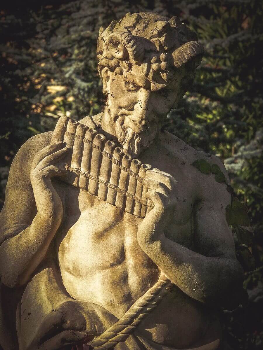 god of shepherds Pan Shepherd god Pan with his flute - a statue in the park