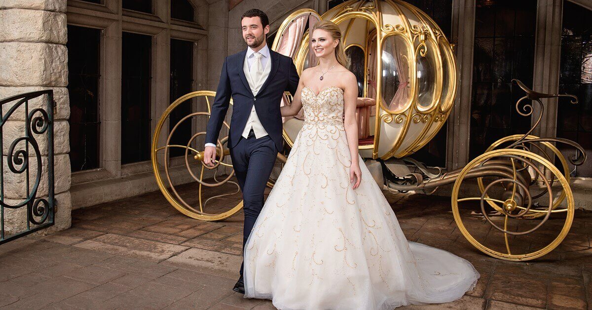 A dream wedding in Disneyland Paris Happy bride and groom celebrate their dream wedding in front of the Cinderella carriage at the Auberge de Cendrillon