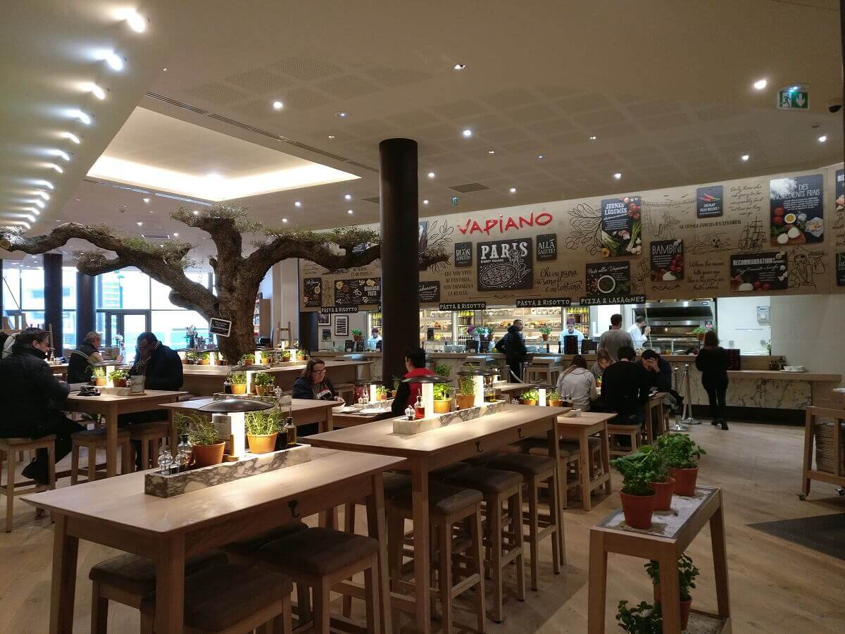 The inside of the Vapiano at Disney Village The inside of the Vapiano in Disney Village, view over tables to the counter, on the left the big old olive tree