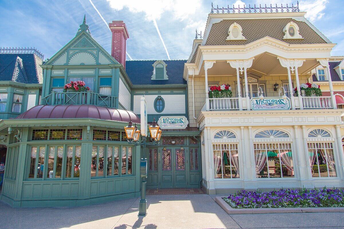 Facade of Victoria's Home-Style Restaurant Facade of Victoria's Home-Style Restaurant. On the left a green building with a winter garden with metal roof, on the right a white building with a large roof terrace.