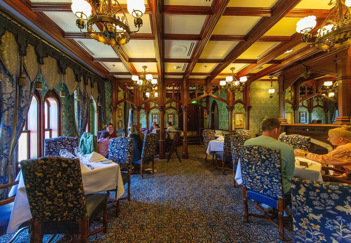 Fantasyland Room The Fantasyland Room at Walt's - An American Restaurant. Richly decorated room with wooden arcades reminiscent of the castle