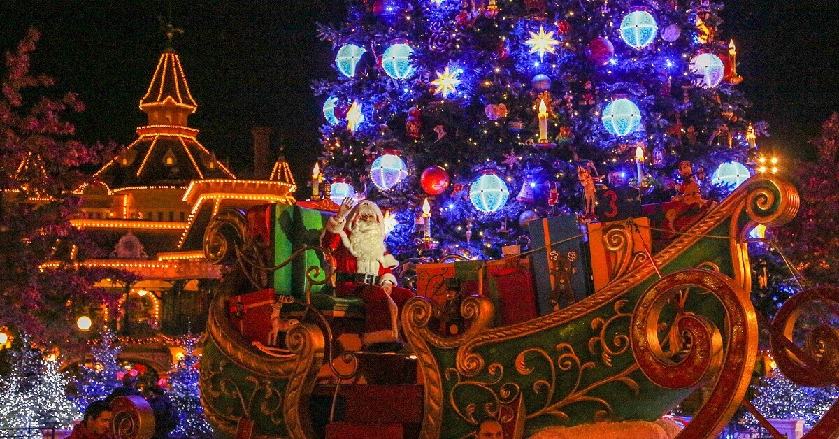 Christmas at Disneyland Paris Santa Claus stops in his sleigh in front of the magnificent illuminated Christmas tree
